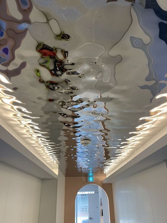 the ceiling is decorated with many different colors and shapes, including water droplets on it