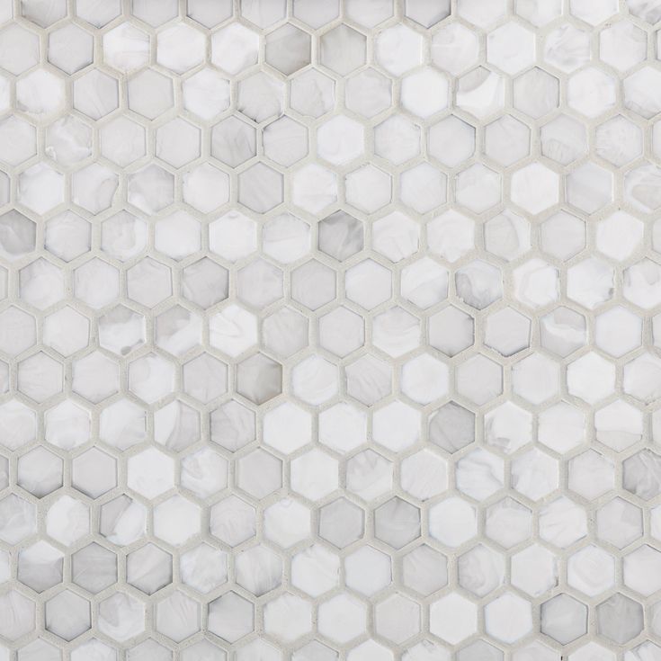 a white tiled wall with hexagonal tiles