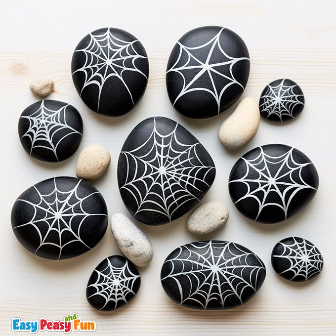 some black and white rocks with spider web designs on them