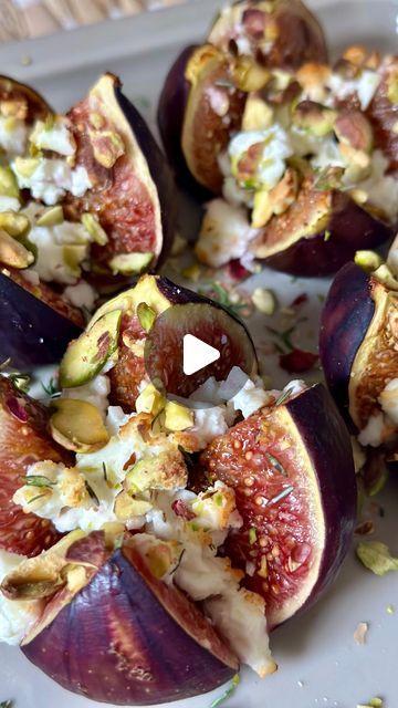 figs with nuts and cheese on a white plate