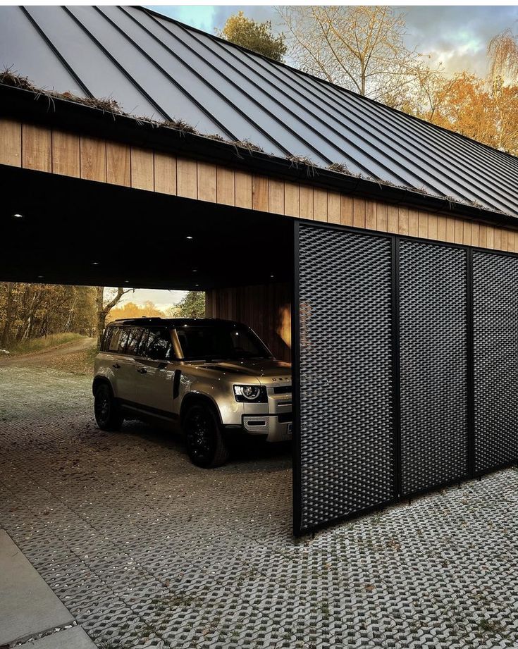 a car is parked in front of a garage door with a metal grid on the side