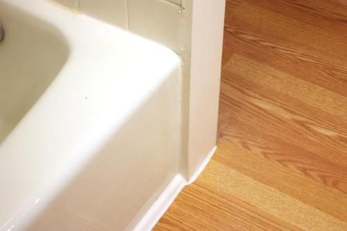 a bathroom sink sitting on top of a wooden floor