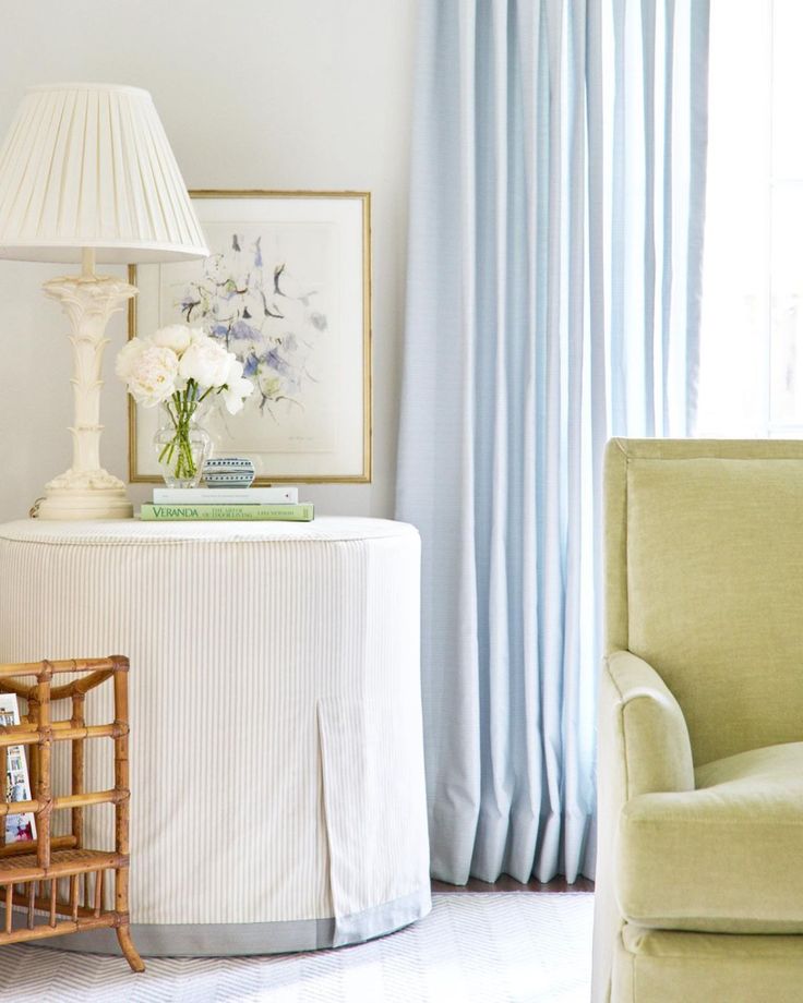 a living room with a couch, table and lamp