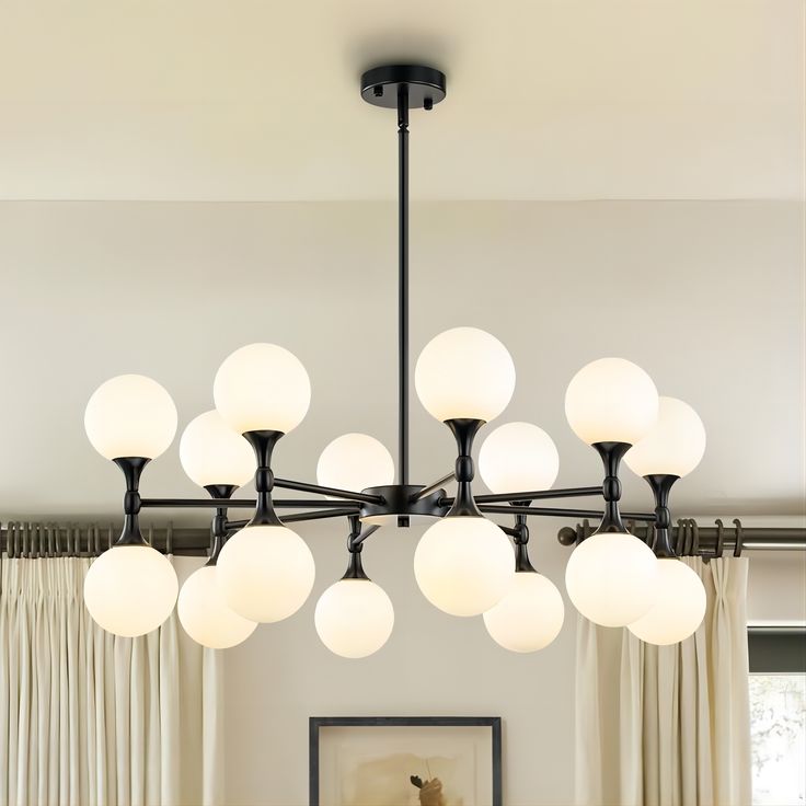 a modern chandelier hangs over a dining room table