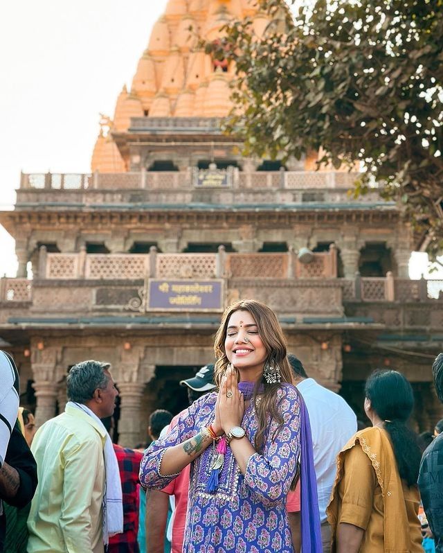 a woman standing in front of a temple