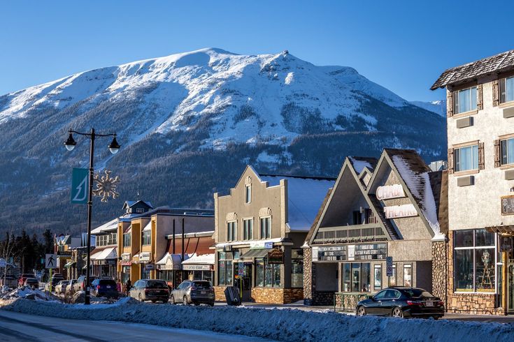 a town with snow covered mountains in the background