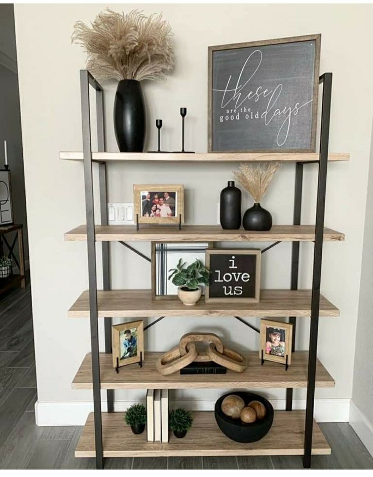 a shelf with some pictures and other items on top of it in a living room