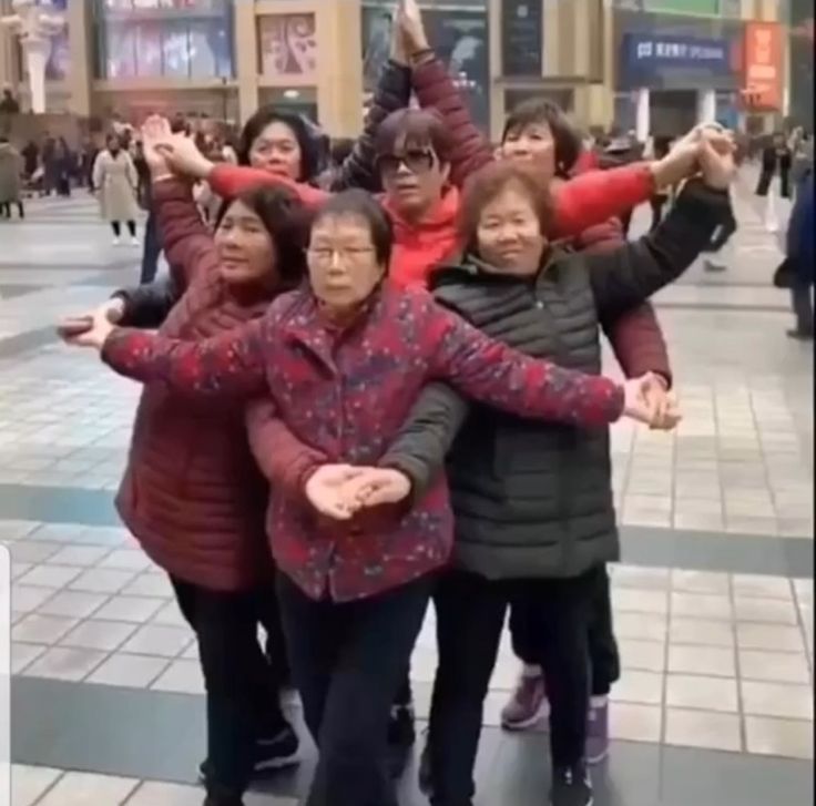 group of people posing for the camera in front of a building