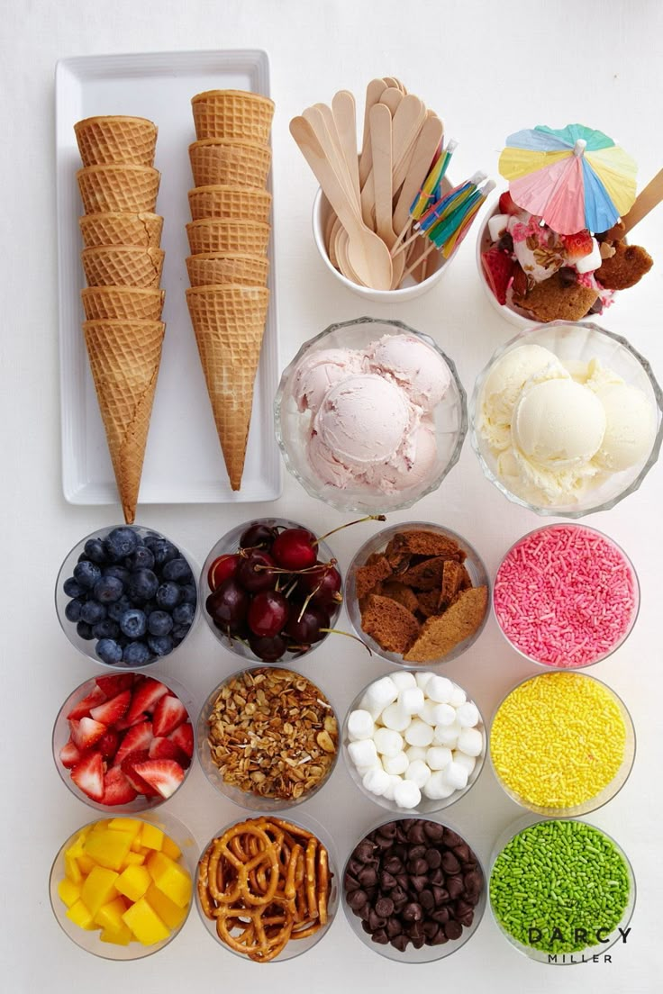 an ice cream sundae with toppings in bowls