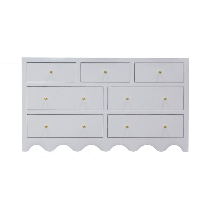 a white dresser with gold knobs on the top and bottom drawers, against a white background