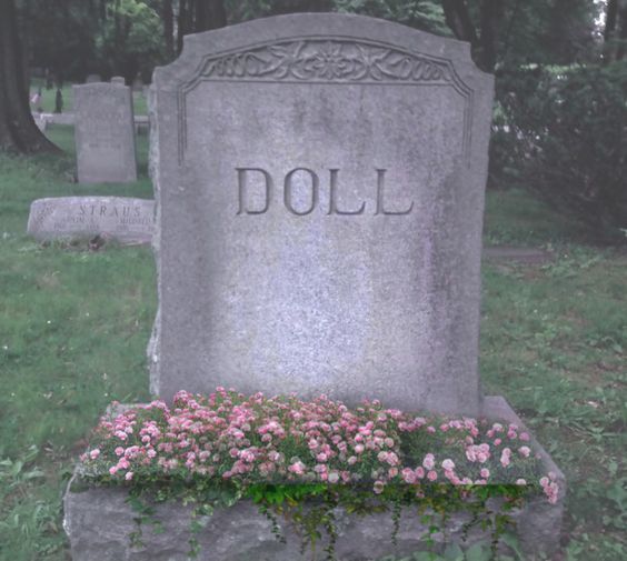 a headstone with flowers in the foreground