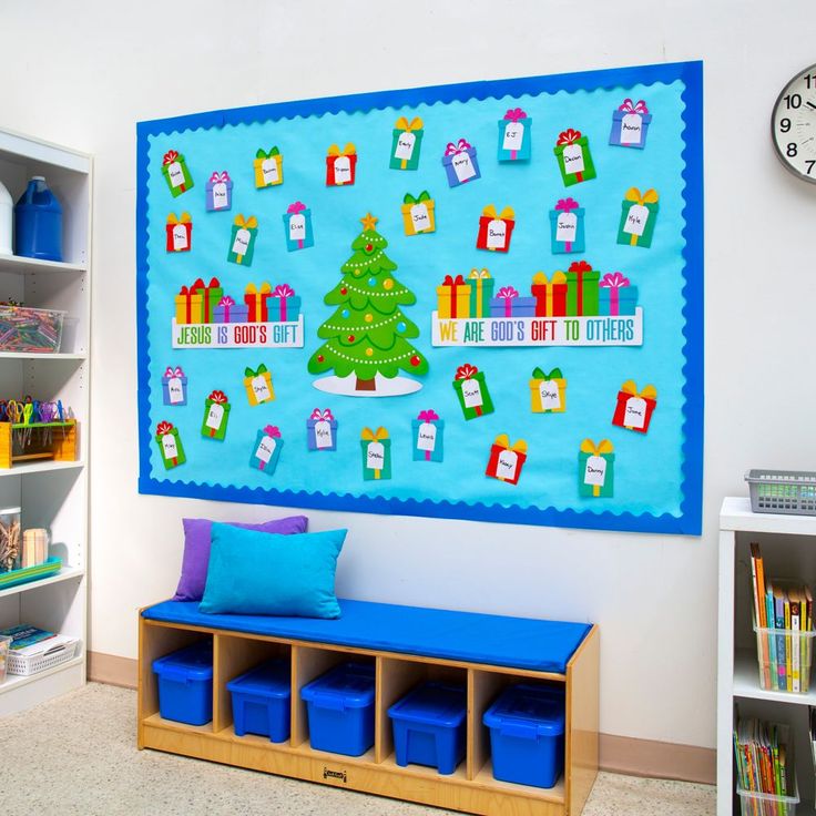 there is a christmas tree and presents on the bulletin board in this room with blue bins