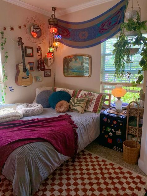 a bed room with a guitar on the wall