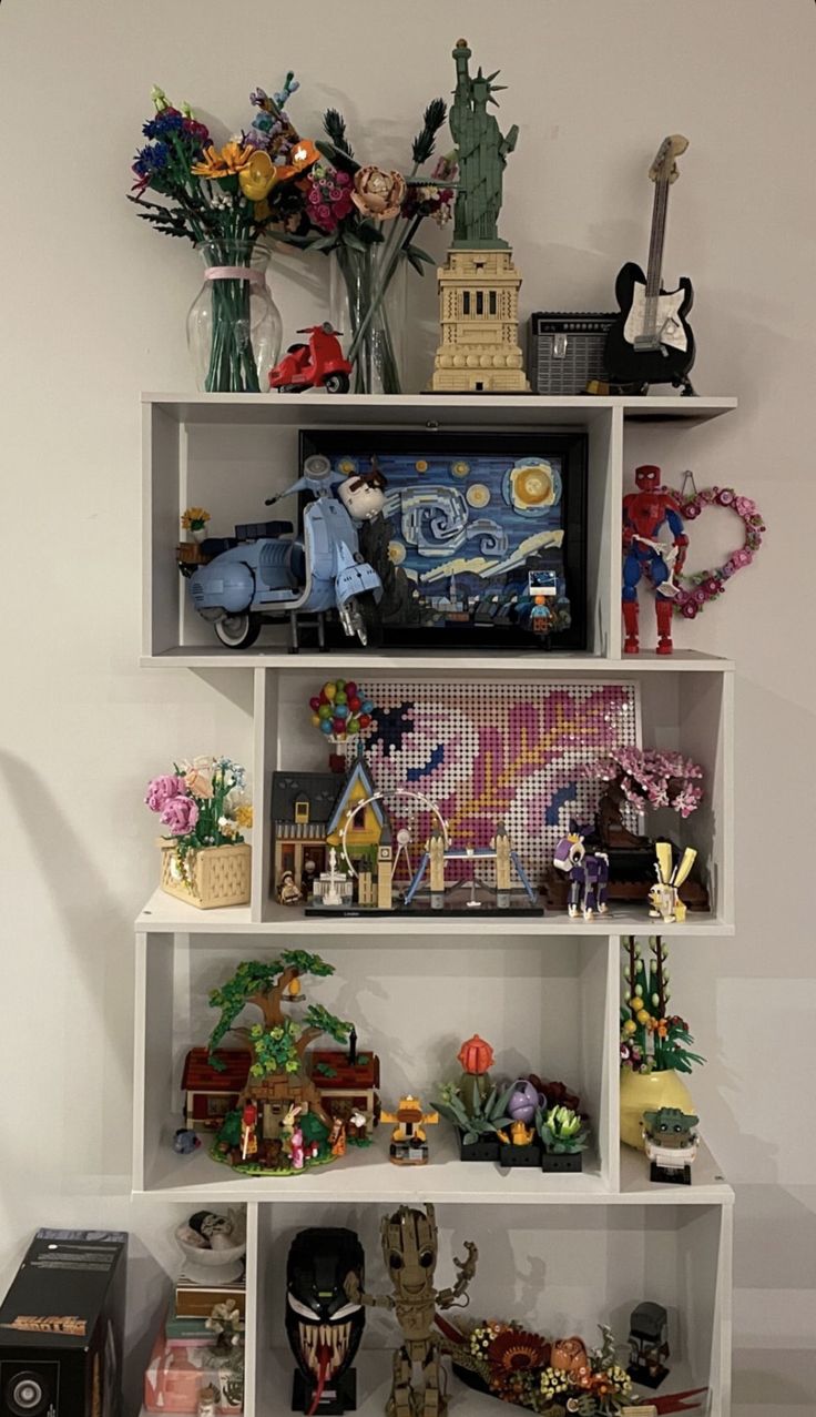 a shelf filled with figurines and knick - knacks on top of each other