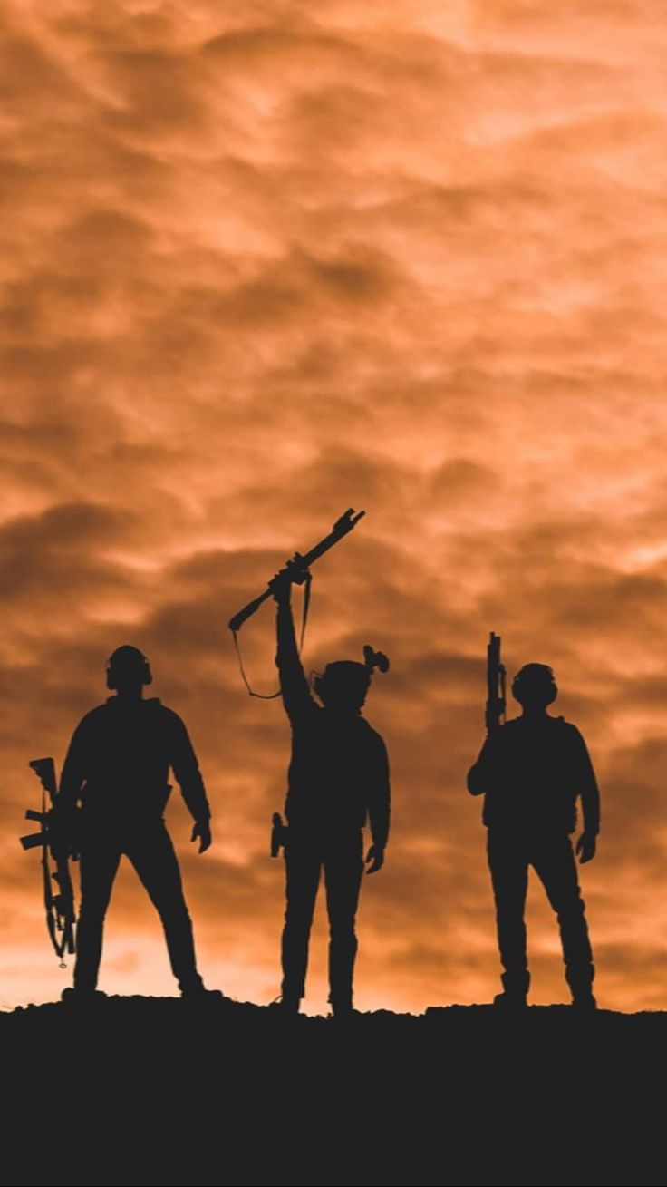 the silhouettes of three men with their arms in the air