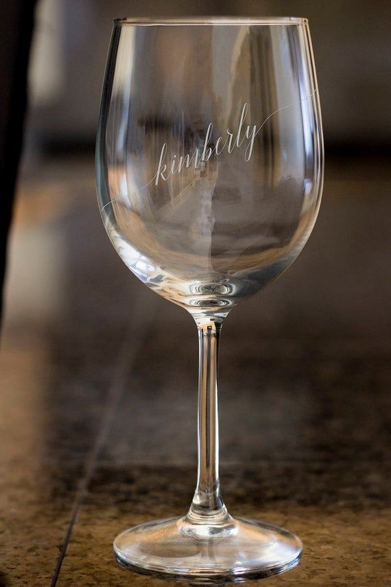 a clear wine glass with the words thank you on it