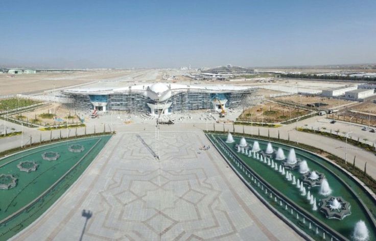 an aerial view of a large building with many fountains