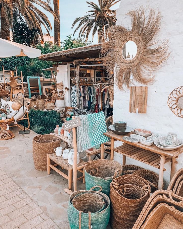 an outdoor shop with wicker baskets and palm trees