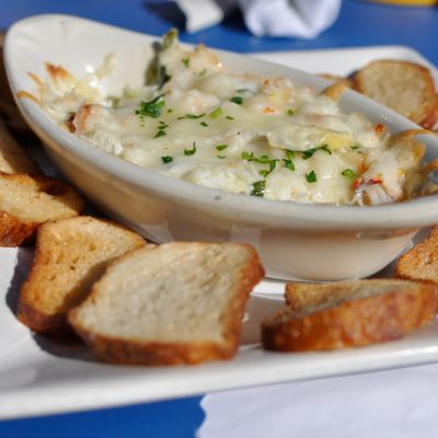 a white bowl filled with cheese and crackers