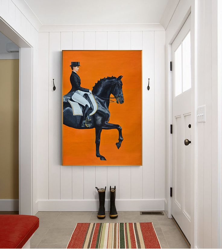 an orange and black horse painting hangs on the wall