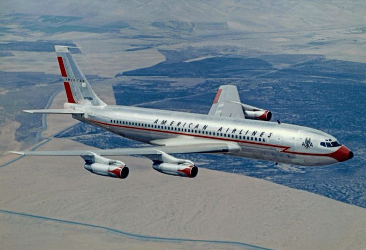 an american airlines jet flying over the desert land and mountains in the background, as seen from above