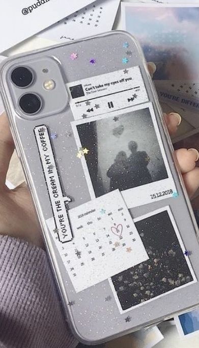 someone holding up their cell phone case with pictures on the back and side, in front of them