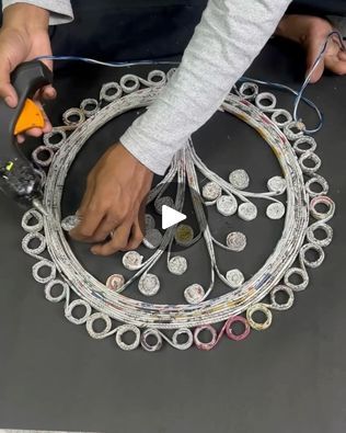 a person is working on something with scissors and wires in the shape of a circle