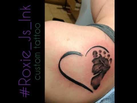 a heart shaped tattoo with a dog's paw in it