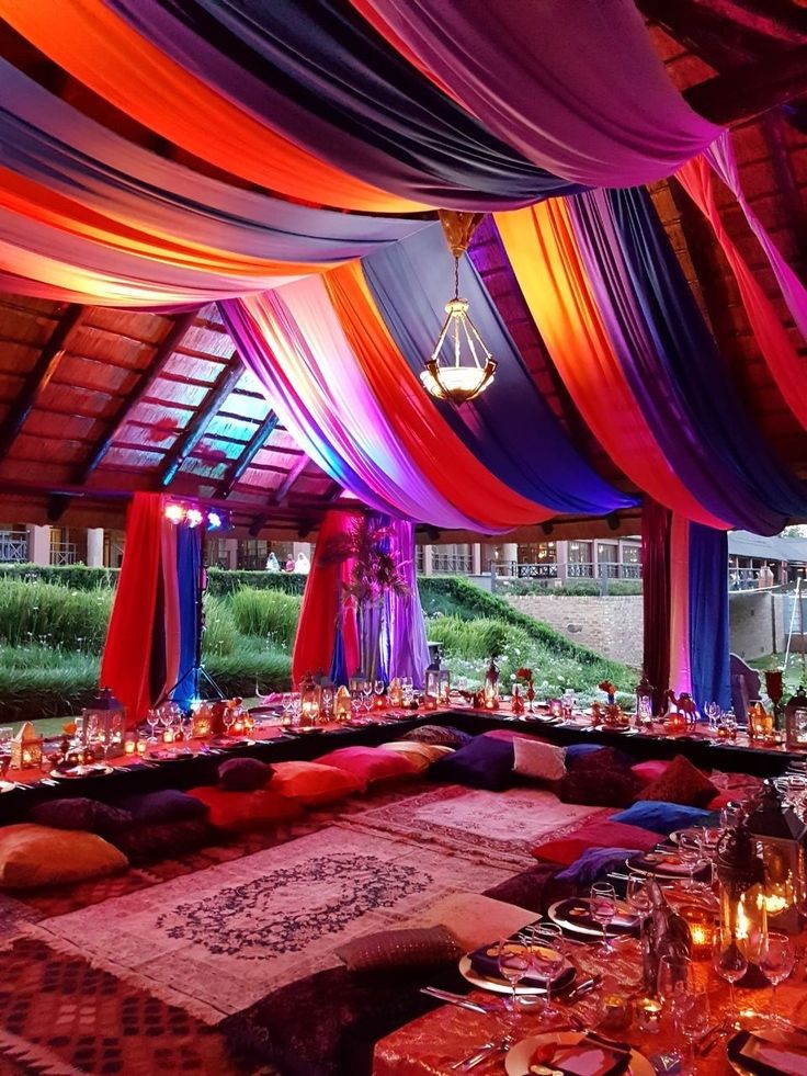 a banquet hall decorated with colorful draping and place settings