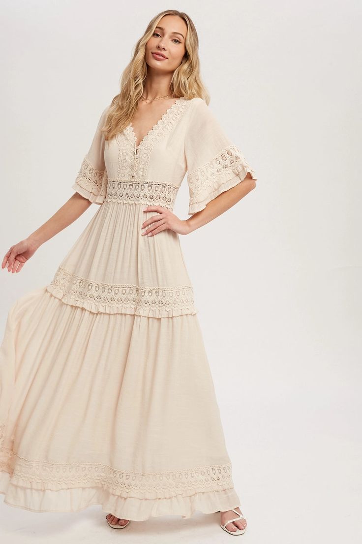 Introducing the Plains Western Lace Maxi Dress in Cream. This beautiful dress fits true to size and is perfect for any occasion. Its stunning lace detailing makes it a pretty and elegant choice for any maxi dress lover. Enhance your wardrobe with this timeless piece. Summer Maxi Dress With Scalloped Lace And Short Sleeves, Summer V-neck Maxi Dress With Scalloped Lace, Flowy V-neck Midi Dress With Lace Trim, Bohemian V-neck Dress With Crochet Trim, Spring Maxi Dress With Scalloped Lace And Short Sleeves, Scalloped Lace V-neck Maxi Dress, V-neck Lace Maxi Dress With Scalloped Lace, V-neck Lace Maxi Dress With Scalloped Edges, Bohemian V-neck Dress With Scalloped Lace