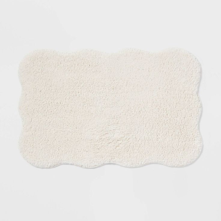 a white area rug on top of a white flooring pad with no one in it