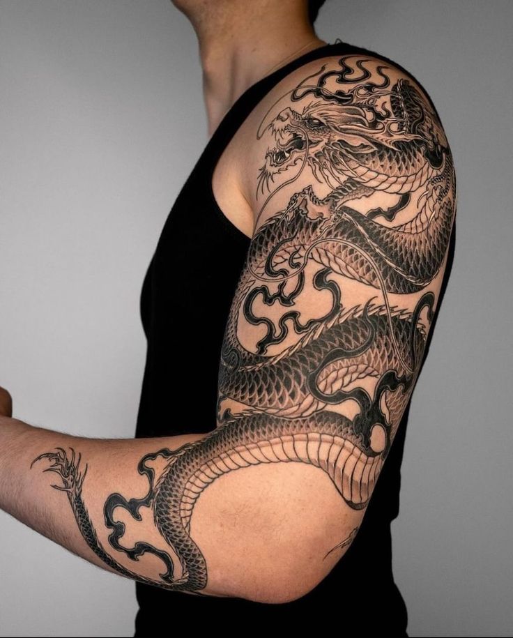 a man with a dragon tattoo on his arm