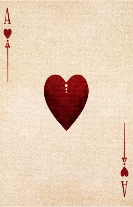 a red heart in the middle of playing cards