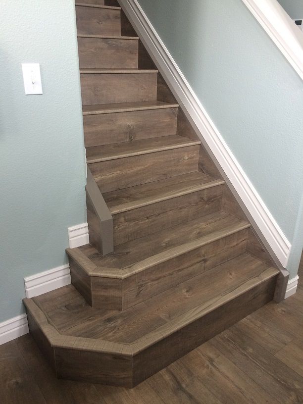 there is a wooden stair case on the floor in this house with light blue walls and wood floors