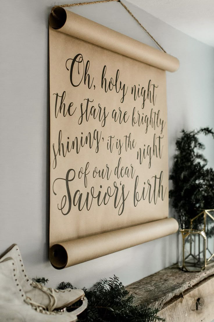 a wooden sign hanging on the wall above a mantle with shoes and potted plants