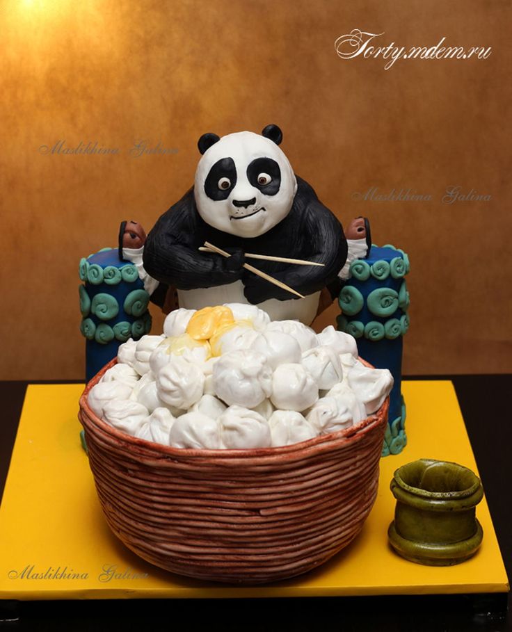 a cake made to look like a panda bear sitting in a basket with marshmallows