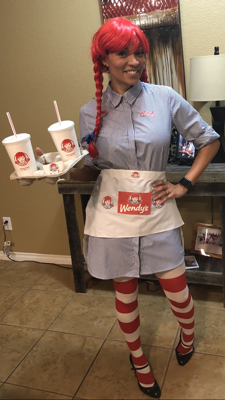 a woman with red hair wearing an apron and striped stockings holding two cups of ice cream