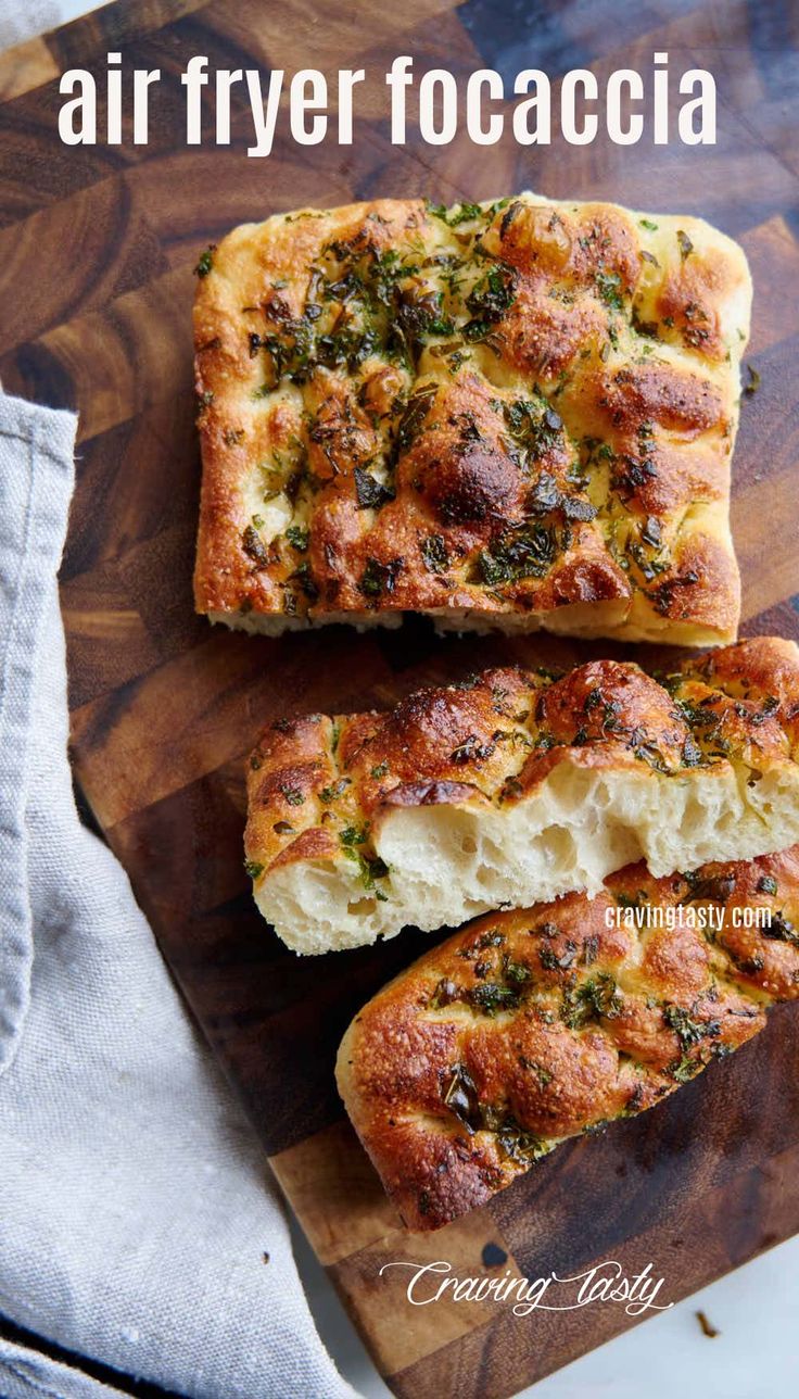 two pieces of bread sitting on top of a wooden cutting board