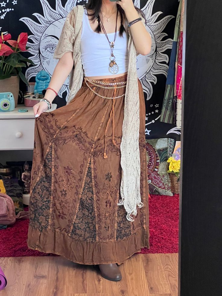 Introducing our Pari Vintage Vibe Brown Embroidery Maxi Skirt, perfect for embracing those boho and hippie vibes! This stunning skirt features pleated borders that add a touch of elegance, while the maxi length offers a chic and comfortable fit.Crafted with fairly-core fashion inspiration, this skirt is ideal for creating enchanting cottage-core looks. Whether you're strolling along sandy shores or exploring hidden getaways, this skirt will ensure you're dressed to impress. Its flowing silhouette captures the essence of fairy-core aesthetics, evoking a sense of whimsy and magic.Designed for the boho fashionista in you, it is versatile and easy to style. Pair it with a cropped top and woven sandals for a carefree bohemian look, or opt for a lace blouse and floppy hat for a more sophisticate Hippie Boho Outfits, Vibe Brown, Core Aesthetics, Core Fashion, Boho Whimsical, Brown Embroidery, Enchanted Cottage, Hippie Aesthetic, Rave Costumes