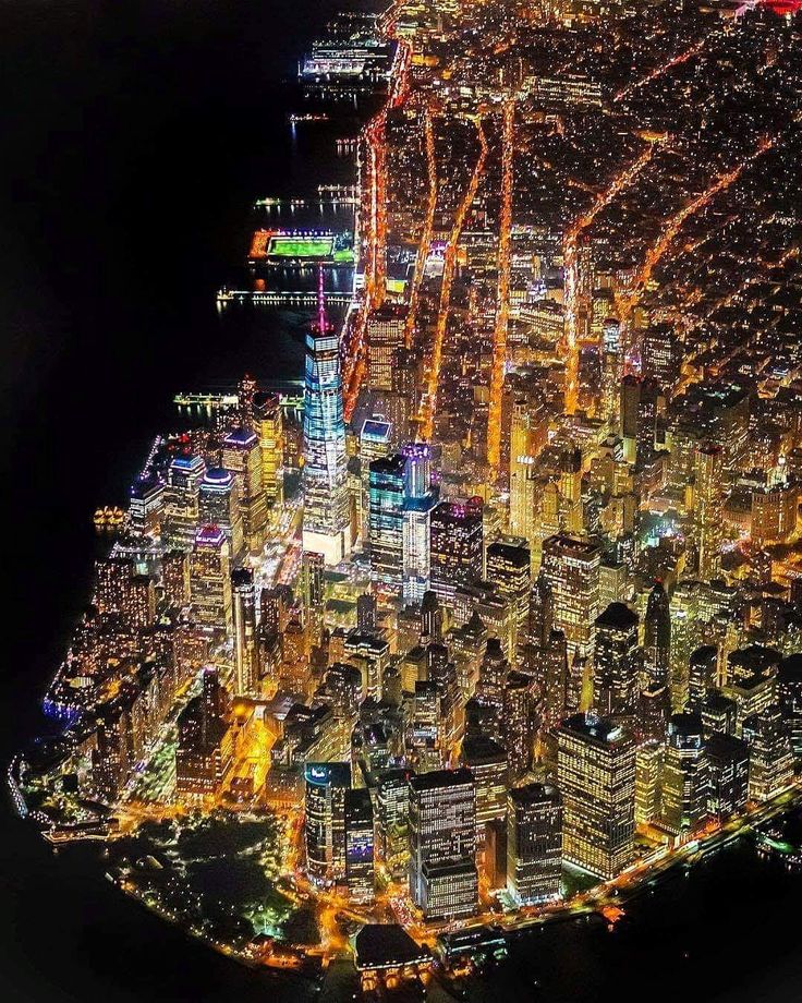 an aerial view of the city lights at night from high up in the sky,