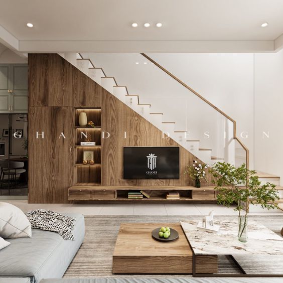 a living room filled with furniture and a flat screen tv sitting on top of a wooden shelf