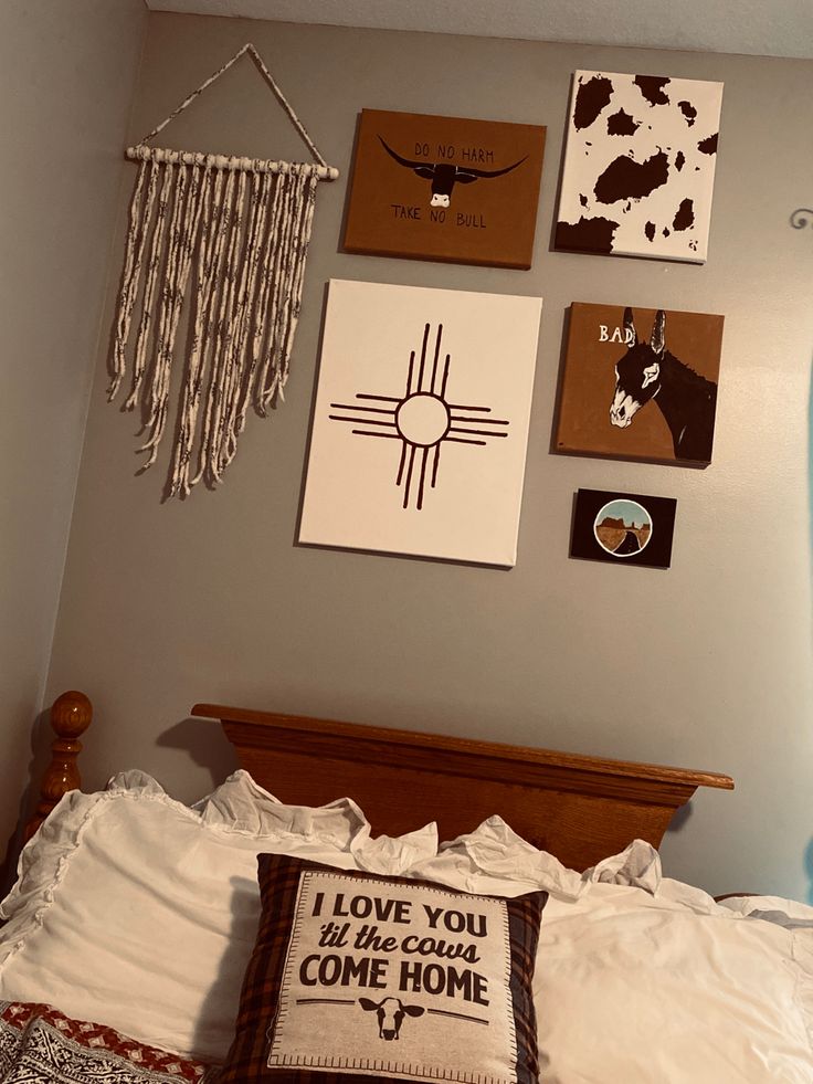 a bed with pillows and pictures on the wall above it that says i love you, we're home