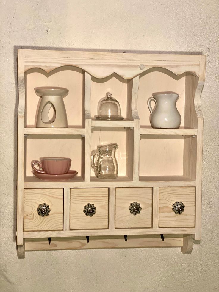 a shelf that has some cups and pitchers on it