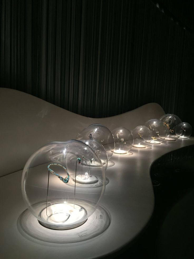 a group of glass balls sitting on top of a white table next to each other