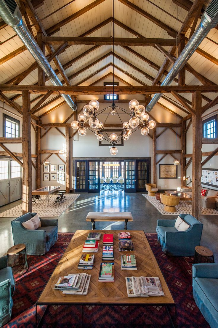 the inside of a large building with lots of windows and wooden beams on the ceiling