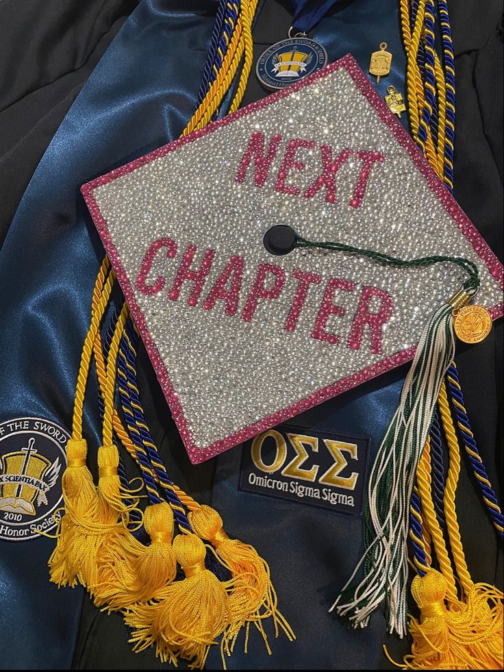 a graduation cap with the words next charter written on it and tassels hanging down