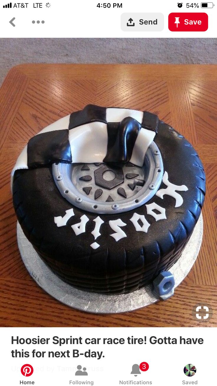 a black and white cake sitting on top of a wooden table