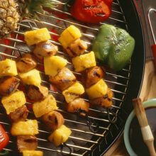 pineapples and peppers are on the grill with chopsticks next to them