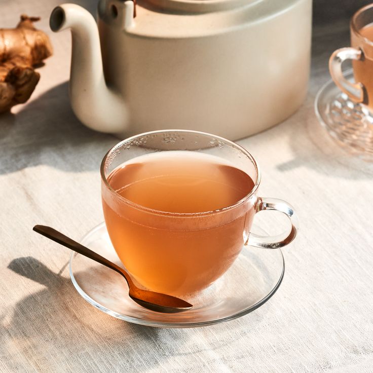 a cup of tea on a saucer with a spoon