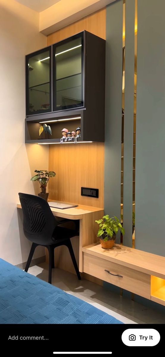 a bed room with a neatly made bed next to a desk and cupboards on the wall